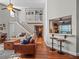 Open-concept living room with hardwood floors, a staircase to the second floor, and kitchen access at 128 Waverly Pl # 128, Orlando, FL 32806