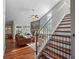 Open living room with hardwood floors, fireplace, large windows, and staircase leading to upper level at 128 Waverly Pl # 128, Orlando, FL 32806