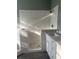 Bathroom showcasing a stand up shower with patterned tile, and a single sink vanity with light countertops at 13018 S Sunset Ter, Winter Garden, FL 34787