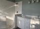 Bathroom featuring a dual sink vanity, mosaic tile shower and modern fixtures at 13018 S Sunset Ter, Winter Garden, FL 34787