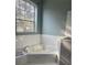 Bathroom with a large soaking tub and a large window at 13018 S Sunset Ter, Winter Garden, FL 34787