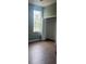 Bedroom with a closet, a window and wood flooring at 13018 S Sunset Ter, Winter Garden, FL 34787