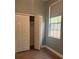 Bedroom featuring neutral walls, modern flooring, a large closet, and natural light from the window at 13018 S Sunset Ter, Winter Garden, FL 34787