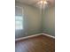 This bedroom features hardwood floors, a ceiling fan, a window with natural light, and neutral paint at 13018 S Sunset Ter, Winter Garden, FL 34787
