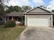 Charming single-story home with a two-car garage and well-maintained front yard at 13018 S Sunset Ter, Winter Garden, FL 34787