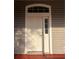 Stylish white front door with transom window providing lots of natural light at 13018 S Sunset Ter, Winter Garden, FL 34787