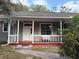 Inviting front porch with a swing and a view of the front yard at 13018 S Sunset Ter, Winter Garden, FL 34787