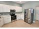 Modern kitchen with stainless steel appliances and white cabinets and countertops at 13018 S Sunset Ter, Winter Garden, FL 34787