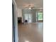 Bright living room with brick fireplace, tile floors, and large windows at 13018 S Sunset Ter, Winter Garden, FL 34787