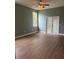 Living room with wood flooring, ceiling fan and french doors at 13018 S Sunset Ter, Winter Garden, FL 34787