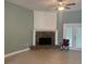 Cozy living room featuring a brick fireplace and access to the outdoors at 13018 S Sunset Ter, Winter Garden, FL 34787