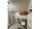 Bathroom featuring a pedestal sink, toilet, and tiled shower at 138 W Stetson Ave, Deland, FL 32720