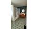 Bathroom featuring a shower-tub combo and vanity with decorative mirror at 138 W Stetson Ave, Deland, FL 32720