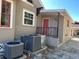 Exterior features AC unit and red door at 138 W Stetson Ave, Deland, FL 32720
