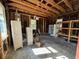 Exposed garage features wood framing and storage shelving at 138 W Stetson Ave, Deland, FL 32720