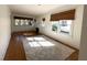 Spacious living room featuring hardwood floors, large windows, and a cozy fireplace at 138 W Stetson Ave, Deland, FL 32720
