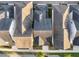 Aerial view showcasing rooftops and neighborhood layout of a residential area with trees and streetscape at 1457 Resolute St, Celebration, FL 34747