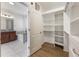 Bathroom view from walk-in closet with double sink vanity, soaking tub, and glass shower at 1457 Resolute St, Celebration, FL 34747