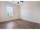Bright bedroom featuring wood-look floors, a ceiling fan, and a large window at 1457 Resolute St, Celebration, FL 34747