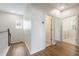 Bright hallway features wood-look flooring, natural light, and access to bathroom and laundry at 1457 Resolute St, Celebration, FL 34747