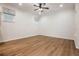 Large living room featuring stylish wood floors, ceiling fan, and ample natural light at 1457 Resolute St, Celebration, FL 34747