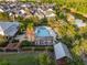 Community pool featuring sun loungers, palm trees, pergola, and surrounding residential area near a lake at 1457 Resolute St, Celebration, FL 34747