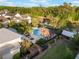 View of the community pool area, featuring palm trees, a pergola, and a glimpse of the nearby lake at 1457 Resolute St, Celebration, FL 34747