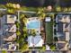 Aerial view of community pool, clubhouse, palm trees, lush landscaping, and nearby lake at 1457 Resolute St, Celebration, FL 34747