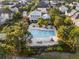 Overhead shot of a community pool with ample seating and lush landscaping, and a nearby clubhouse at 1457 Resolute St, Celebration, FL 34747