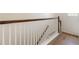 Well-lit staircase featuring wood railing, white balusters, and wood-look flooring at 1457 Resolute St, Celebration, FL 34747