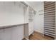 Organized walk-in closet with custom shelving, drawers, and hanging space for efficient storage at 1457 Resolute St, Celebration, FL 34747
