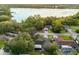 Aerial view of homes surrounded by trees, street, and large lake nearby at 1563 W Finland Dr, Deltona, FL 32725
