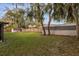 Large backyard featuring lush lawn, mature trees, and wooden fence for privacy at 1563 W Finland Dr, Deltona, FL 32725