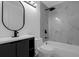 Updated bathroom features a modern vanity and bathtub with tiled walls at 1563 W Finland Dr, Deltona, FL 32725