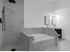 Modern bathroom features a corner tub and a separate walk-in shower at 1563 W Finland Dr, Deltona, FL 32725