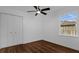Bright bedroom features a ceiling fan, wood-look floors, a window, and closet at 1563 W Finland Dr, Deltona, FL 32725