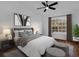 Cozy bedroom with a large window, ceiling fan, and stylish furniture at 1563 W Finland Dr, Deltona, FL 32725