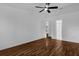 Bright bedroom with wood floors and a ceiling fan and view of another room at 1563 W Finland Dr, Deltona, FL 32725