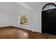Bright entryway featuring wood-look tile flooring, a modern black door, and a large window at 1563 W Finland Dr, Deltona, FL 32725