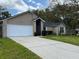 Beautiful single-story brick home with a well-maintained lawn and a two car garage at 1563 W Finland Dr, Deltona, FL 32725