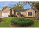 Charming single story brick home with manicured lawn and bright white window shutters at 1563 W Finland Dr, Deltona, FL 32725