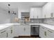 Updated kitchen showcasing white cabinets, quartz countertops, and stainless steel appliances at 1563 W Finland Dr, Deltona, FL 32725