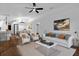 Bright living room featuring hardwood-style flooring, modern decor, and open access to dining area and kitchen at 1563 W Finland Dr, Deltona, FL 32725