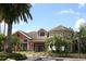 Stunning view of the building exterior featuring lush landscaping and brick paved walkway at 1969 Summer Club Dr # 209, Oviedo, FL 32765