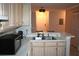 Bright kitchen featuring stainless steel sink, microwave, and light wood cabinetry at 1969 Summer Club Dr # 209, Oviedo, FL 32765