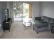 Living room with comfortable seating, sliding glass door to patio, and neutral carpeting at 1969 Summer Club Dr # 209, Oviedo, FL 32765