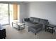 Comfortable living room area with sliding door leading to an outdoor patio at 1969 Summer Club Dr # 209, Oviedo, FL 32765