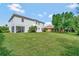 Spacious backyard with lush lawn, screened porch, and mature trees at 2107 Rickover Pl, Winter Garden, FL 34787