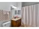 Clean bathroom with a shower, vanity, framed mirror, and stylish towels at 2107 Rickover Pl, Winter Garden, FL 34787