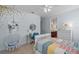 Stylish bedroom featuring hanging chair, desk, and colorful bedding, creating a cheerful and inviting space at 2107 Rickover Pl, Winter Garden, FL 34787